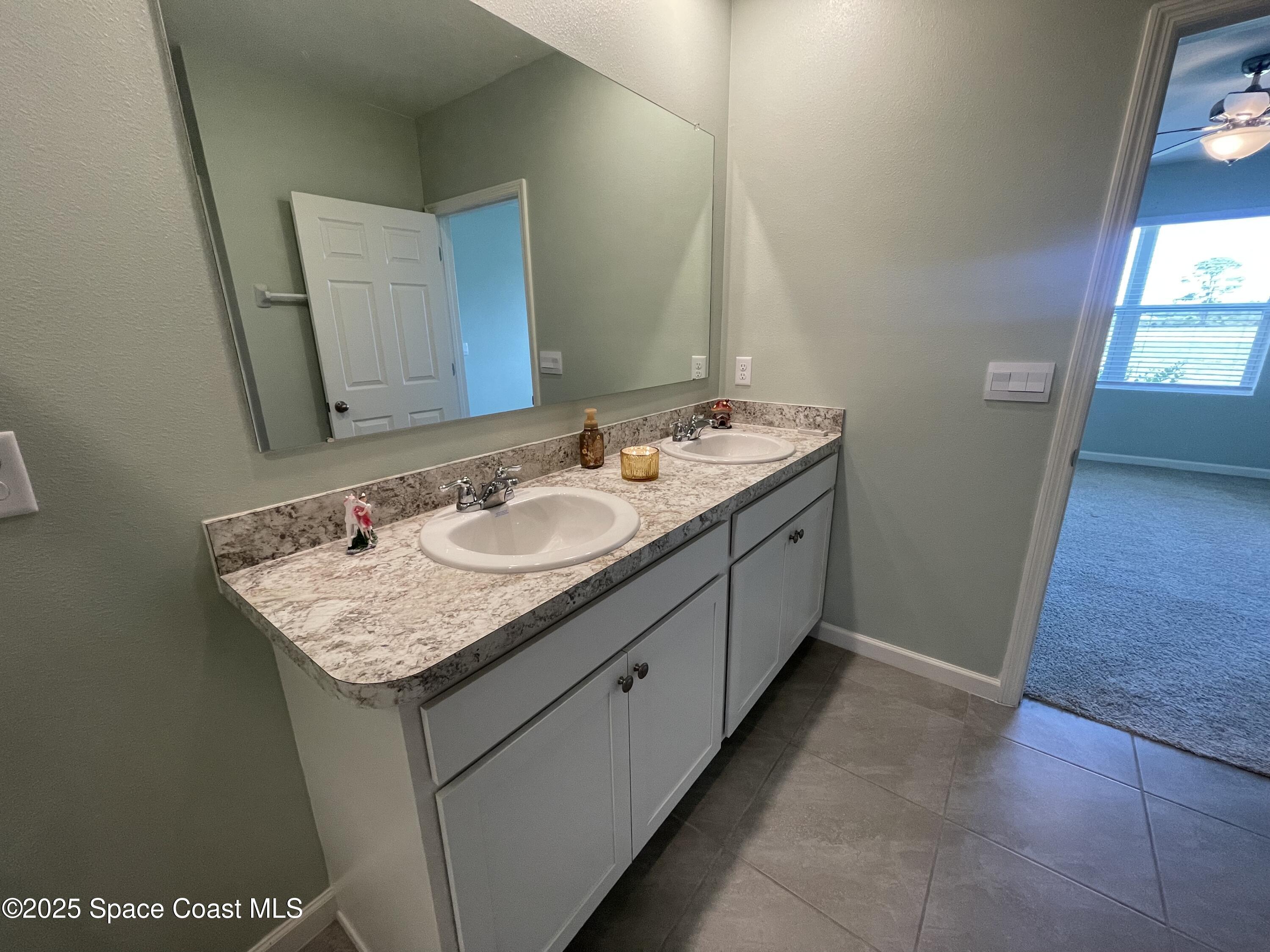 7055 Topaz Drive Grant-Valkaria, FL 32949 - Photo 9 of 24 a bathroom with a sink and a mirror