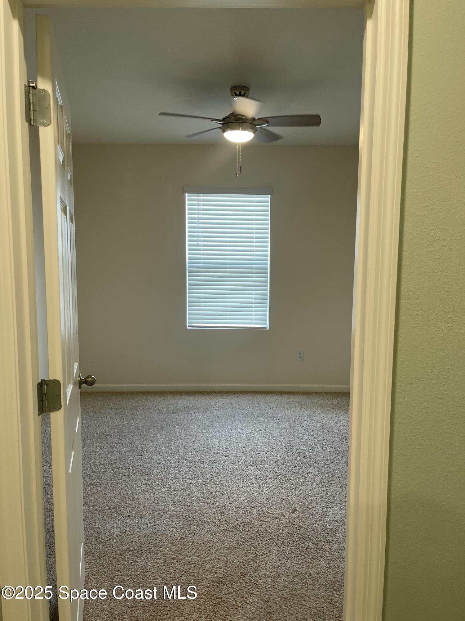 7055 Topaz Drive Grant-Valkaria, FL 32949 - Photo 10 of 24 a view of an empty room with a window