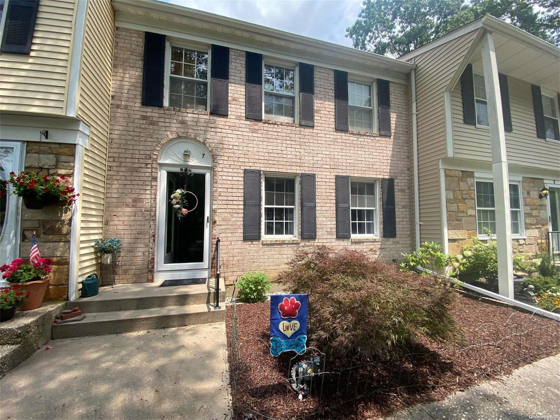 a view of brick house with potted plants