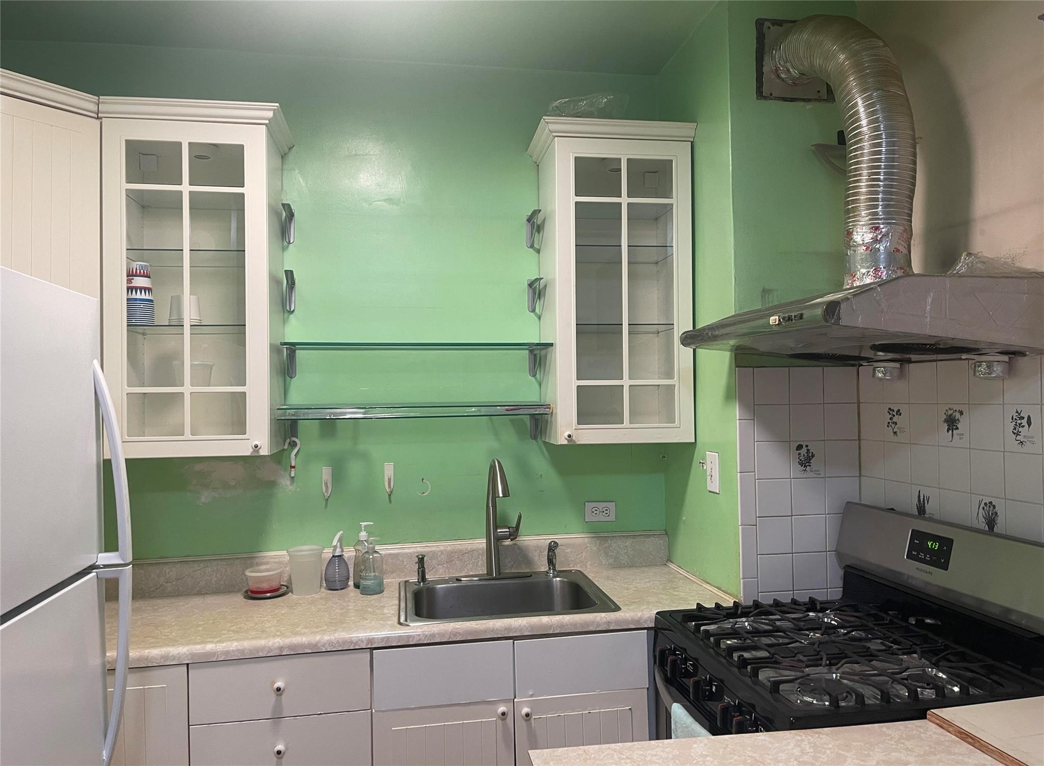 134-54 Maple Avenue, Unit 2S Queens, NY 11355 - Photo 13 of 18 a kitchen with a sink and a stove top oven