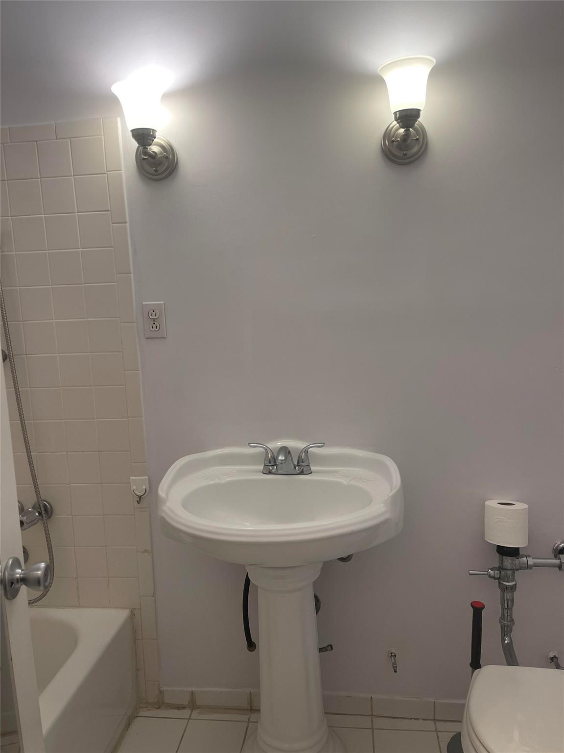 134-54 Maple Avenue, Unit 2S Queens, NY 11355 - Photo 15 of 18 a bathroom with a sink a toilet and mirror