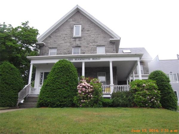 325 Mammoth Road, Unit 2 Lowell, MA 01854 - Photo 1 of 9 a front view of a house with garden