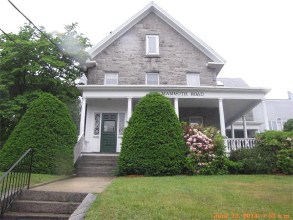 325 Mammoth Road, Unit 2 Lowell, MA 01854 - Photo 2 of 9 a front view of a house with a garden