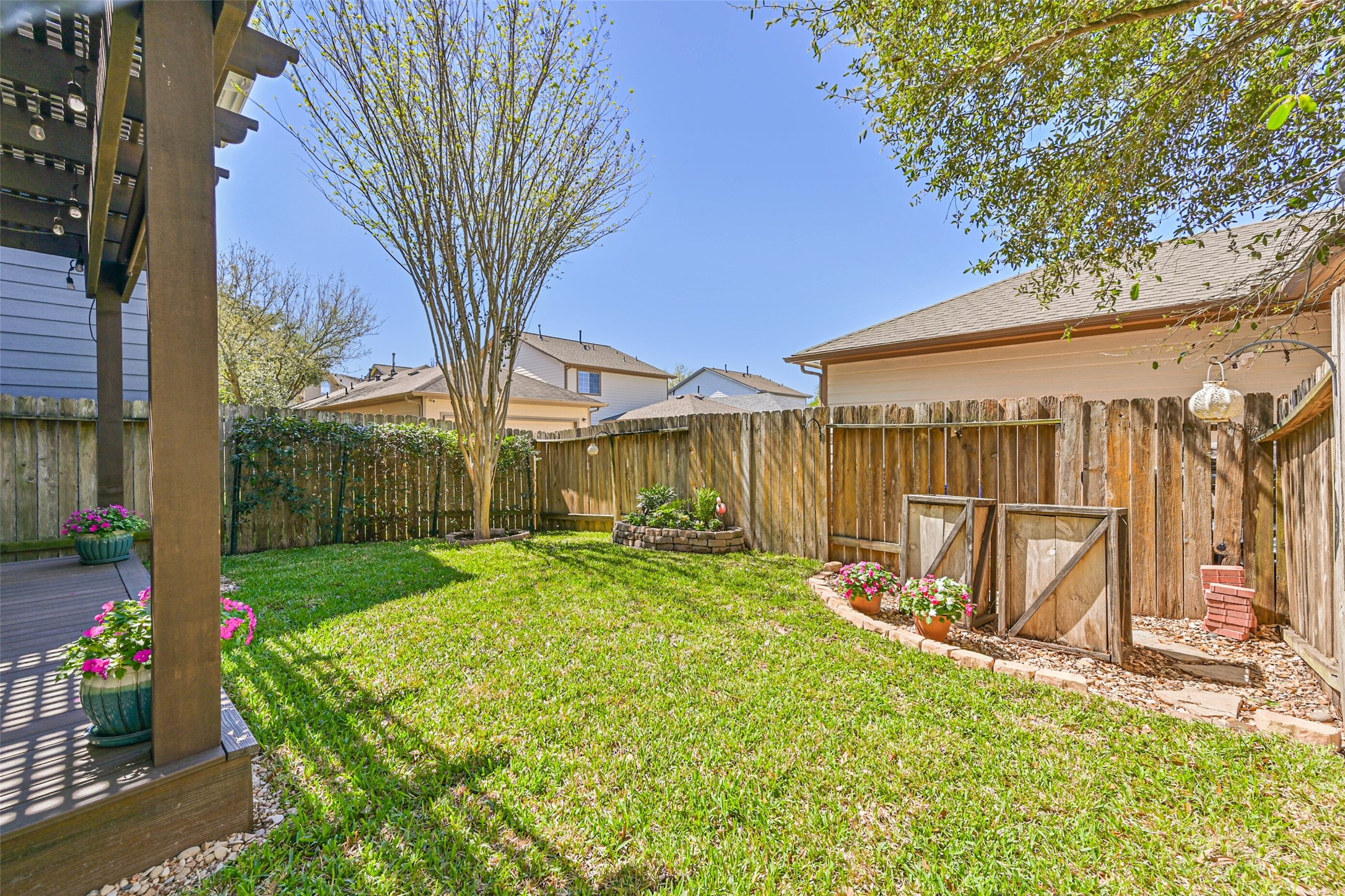 3208 Clearview Circle Houston, TX 77025 - Photo 29 of 30 a view of a backyard with table and chairs with wooden fence and plants