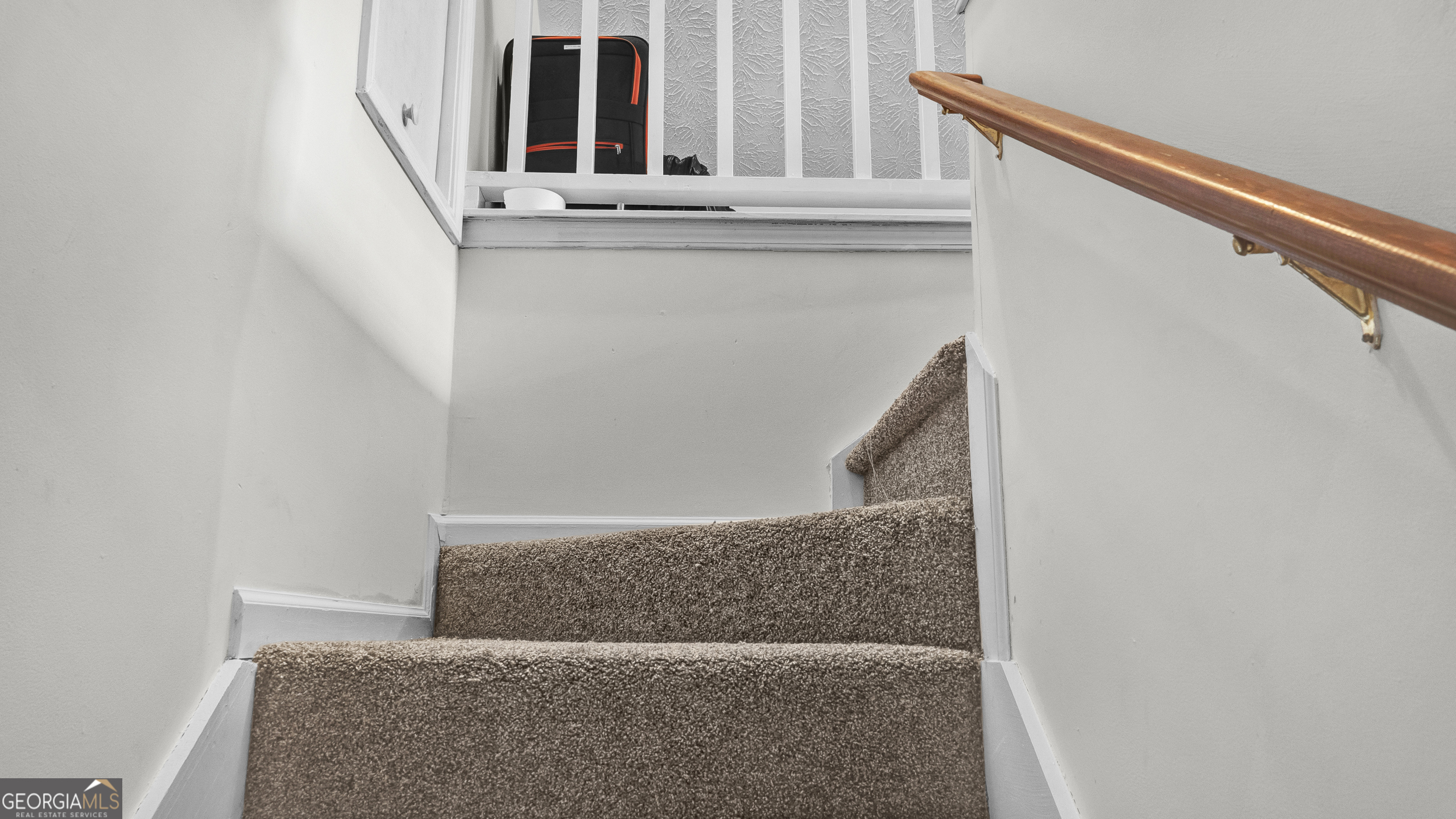 192 Duncans Mill Road Locust Grove, GA 30248 - Photo 11 of 17 a view of staircase with railing and white walls