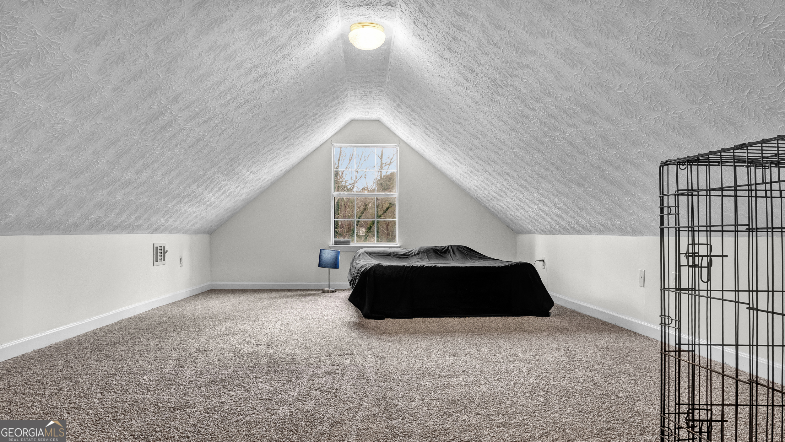 192 Duncans Mill Road Locust Grove, GA 30248 - Photo 12 of 17 a bedroom with a bed and a chandelier fan