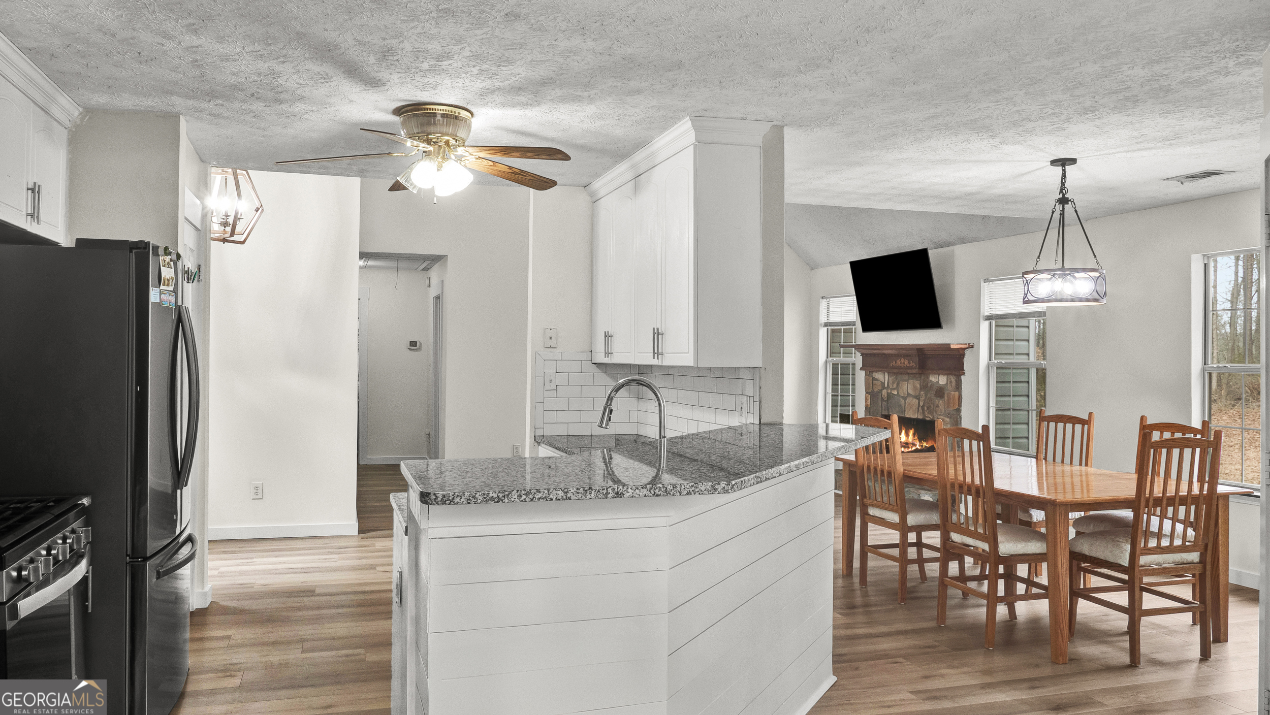 192 Duncans Mill Road Locust Grove, GA 30248 - Photo 6 of 17 a kitchen with kitchen island granite countertop a table and chairs in it