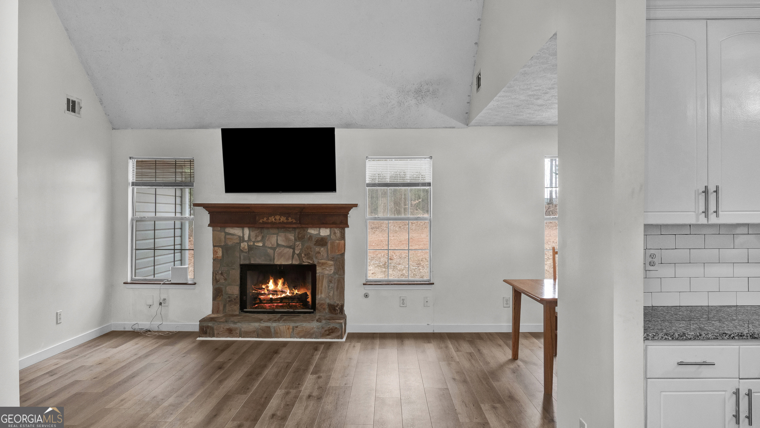 192 Duncans Mill Road Locust Grove, GA 30248 - Photo 8 of 17 a living room with a fireplace and a flat screen tv