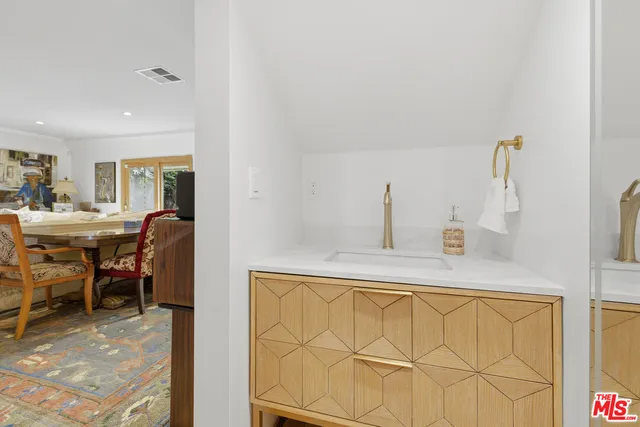 a living room with a sink and furniture