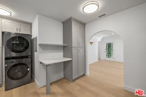 a view of a hallway with washer and dryer