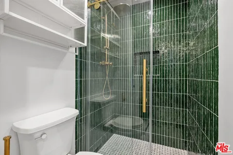 a bathroom with a toilet and a shower