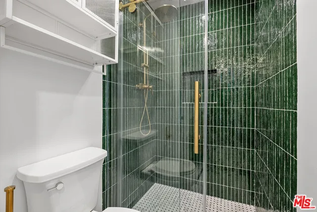 a bathroom with a toilet and a shower