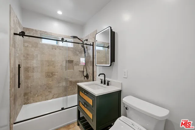 a bathroom with a sink toilet and shower