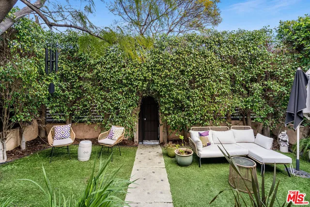 a backyard of a house with table and chairs