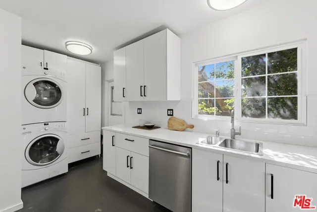 a utility room with sink dryer and washer