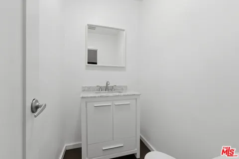a bathroom with a sink toilet and vanity