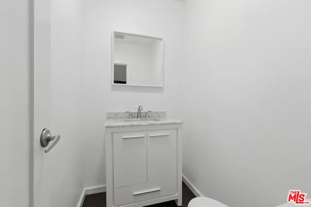 a bathroom with a sink toilet and vanity