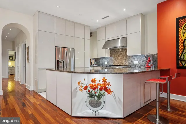 a kitchen with stainless steel appliances granite countertop a sink and a refrigerator
