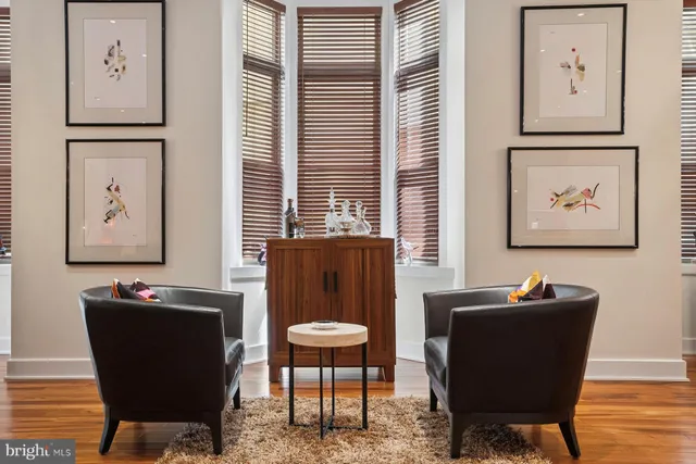 a view of a workspace with furniture and a window