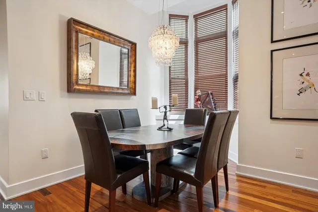 a view of a dining room with furniture and wooden floor
