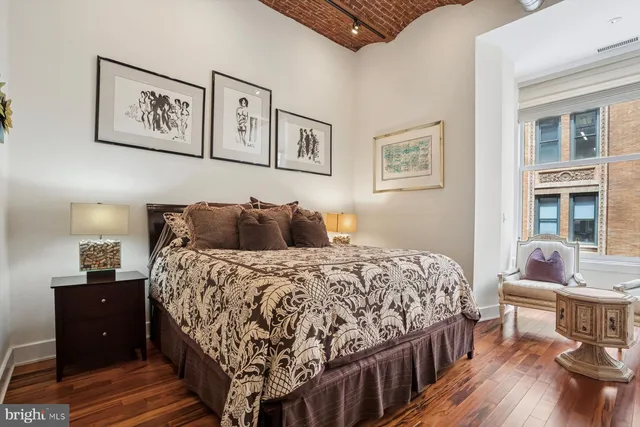 a bedroom with a bed and a table