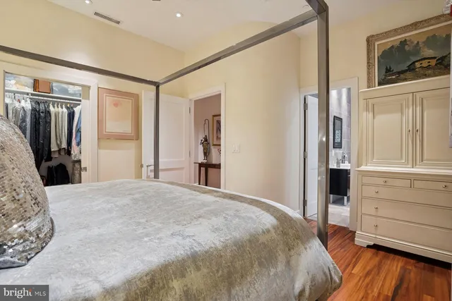 a bedroom with a bed and a dresser