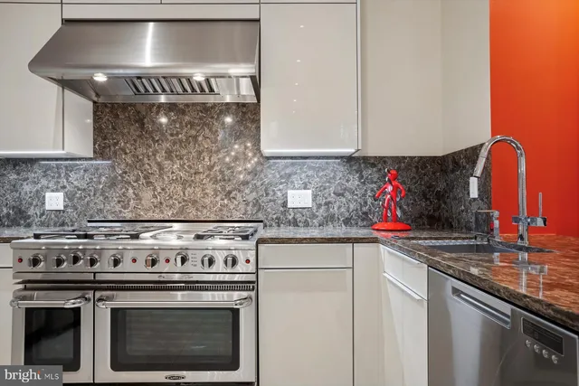 a kitchen with stainless steel appliances granite countertop a stove and a sink