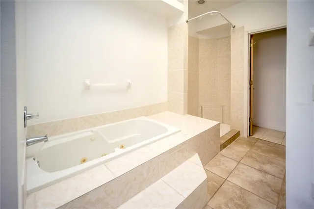 a spacious bathroom with a tub and shower