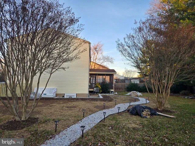 a view of a house with a yard covered with snow and a yard