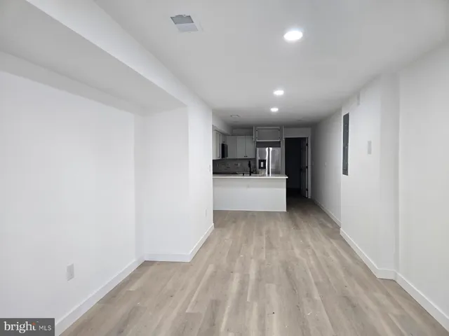 a view of kitchen with sink and refrigerator