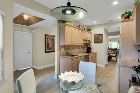 a view of a dining room with furniture and chandelier