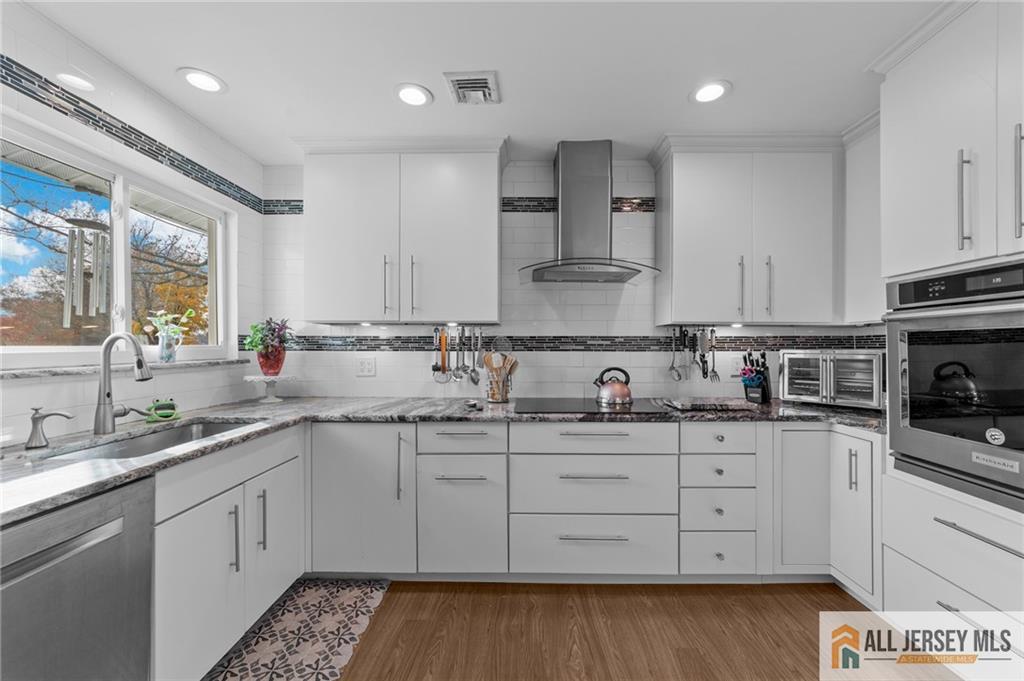 a kitchen with a sink stove and cabinets