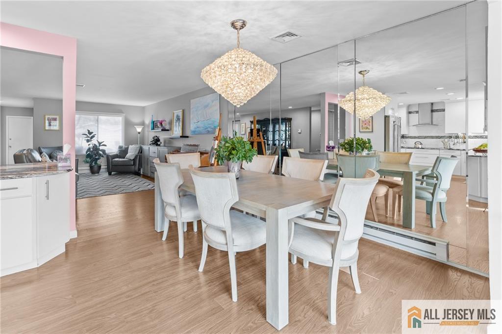 264A Glen Road, Unit 264A Monroe Township, NJ 08831 - Photo 14 of 31 a view of a dining room with furniture wooden floor and chandelier