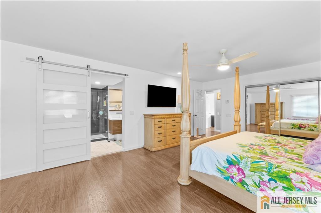 264A Glen Road, Unit 264A Monroe Township, NJ 08831 - Photo 18 of 31 a bedroom with a bed and flat screen tv