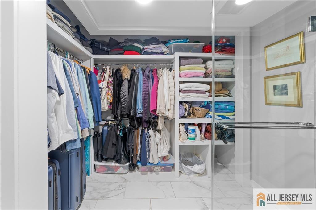 264A Glen Road, Unit 264A Monroe Township, NJ 08831 - Photo 20 of 31 a view of walk in closet with clothes and shoes