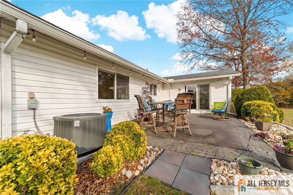264A Glen Road, Unit 264A Monroe Township, NJ 08831 - Photo 26 of 31 a view of a patio with table and chairs and potted plants