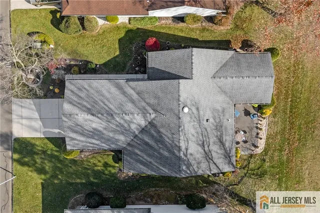 an aerial view of multi story residential apartment building with yard