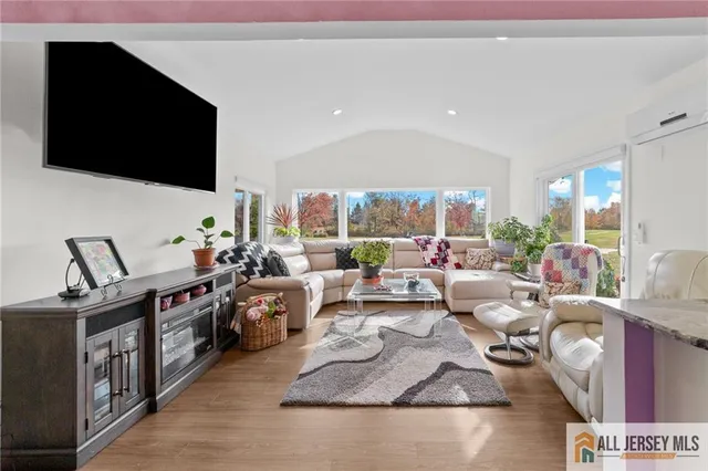 a living room with lots of furniture and a flat screen tv