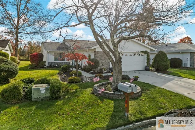 a backyard of a house with fireplace table and chairs