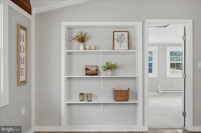 an empty room with windows and closet