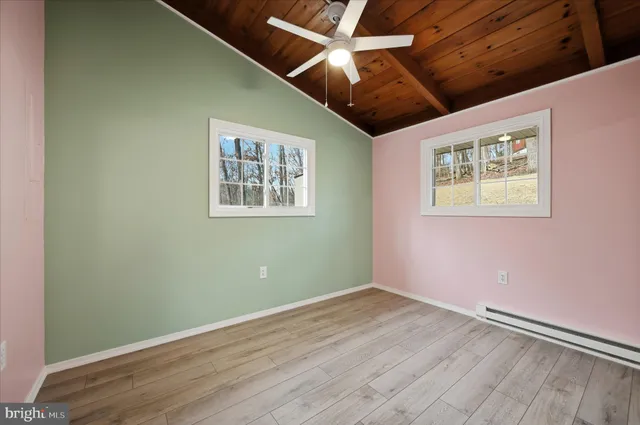 a view of a house with a yard covered in snow