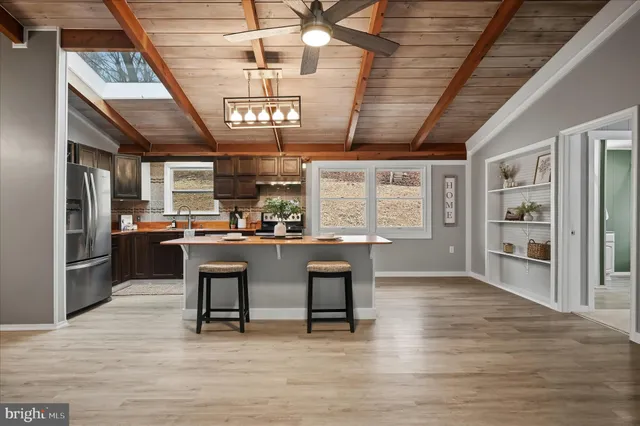 a room with stainless steel appliances kitchen island a large island in the center