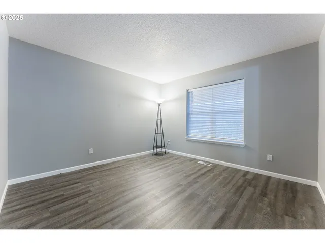 a view of an empty room and wooden floor