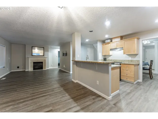 a kitchen with a refrigerator and a stove top oven