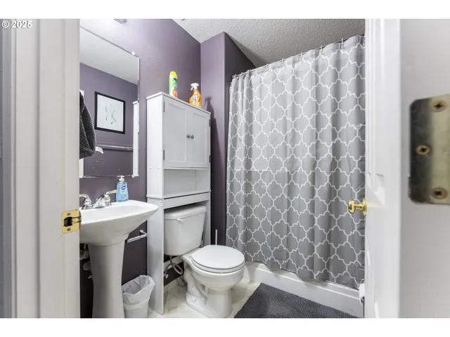 a bathroom with a toilet sink and shower
