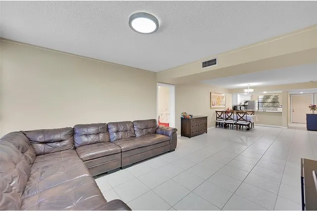 a living room with furniture and swimming pool