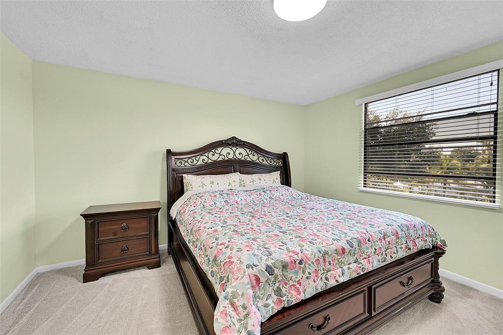 6109 Balboa Circle, Unit 305 Boca Raton, FL 33433 - Photo 17 of 22 a bedroom with a bed and a window