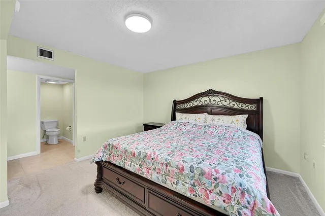 a bedroom with a bed and chair