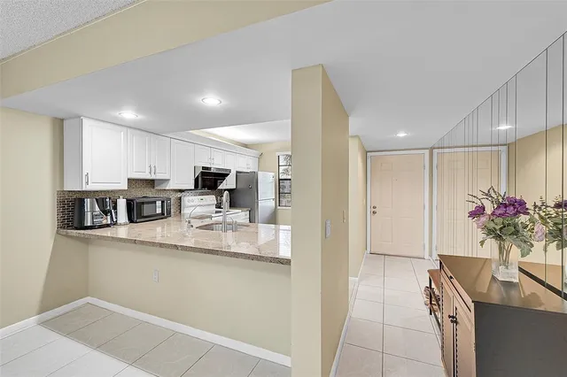 a kitchen with stainless steel appliances kitchen island granite countertop a sink and cabinets