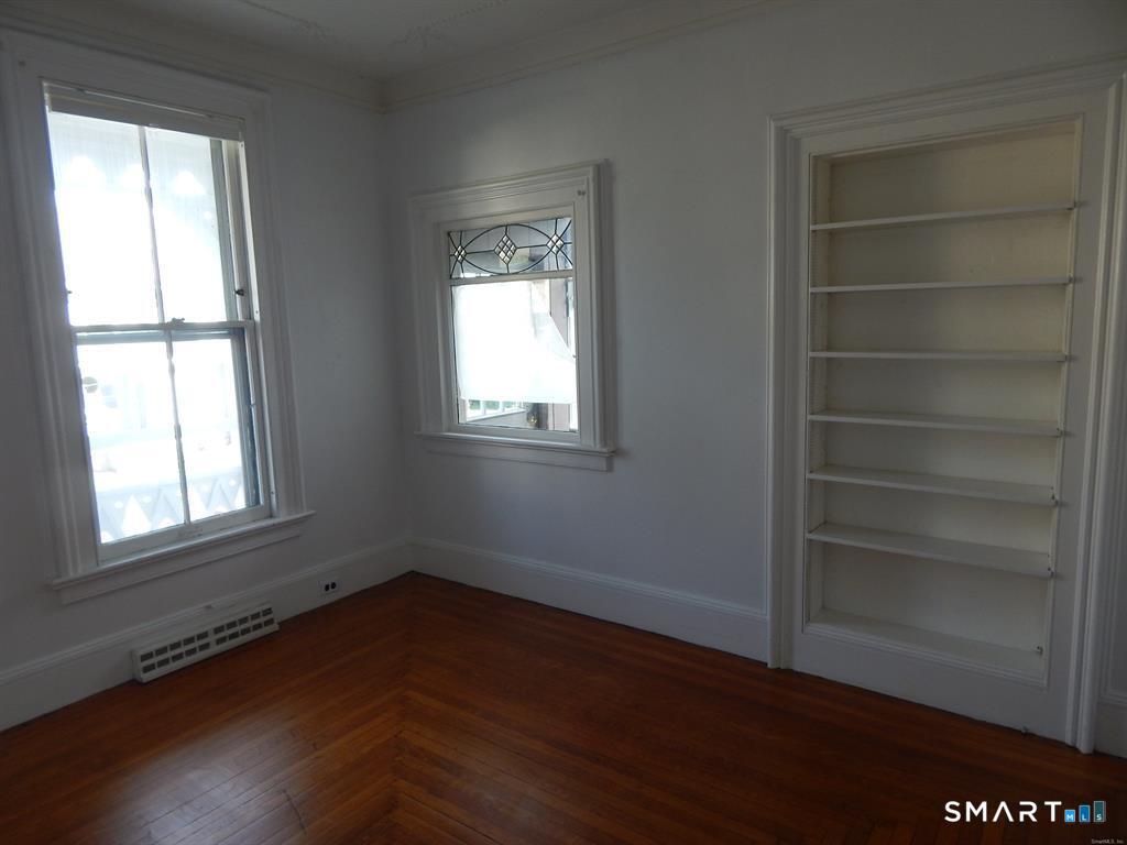 5 Clover Street Ansonia, CT 06401 - Photo 5 of 10 a view of an empty room with a window and wooden floor